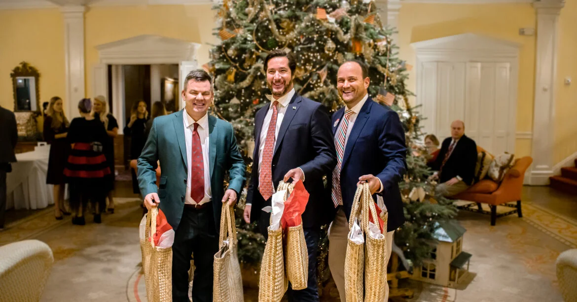Rupert Hayward, Marc Weller, and Matt Rienzo holding gifts for Grand Bahama Children's Home